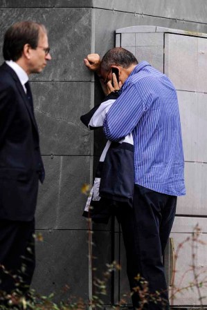 SANTIAGO DE COMPOSTELA, SPAIN - JULY 25: A relative of passengers involved in the train crash talk on his mobile phone as he waits for news at the Cersia Building on July 25, 2013 in Santiago de Compostela, Spain. The crash occurred on Wednesday at 8.40pm as the train approached the north-western Spanish city of Santiago de Compostela, with 247 passengers on board. At least 77 people have died and a further 131 have been reported injured. The crash occurred on the eve of Santiago de Compostela's main religious festival, which has been cancelled by the City's officials. (Photo by David Ramos/Getty Images)