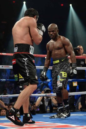 LAS VEGAS, NV - OCTOBER 12: WBO welterweight champion Timothy Bradley Jr. (R) taunts Juan Manuel Marquez during their bout at the Thomas & Mack Center on October 12, 2013 in Las Vegas, Nevada. Timothy Bradley Jr. wins in a split-decision victory over Juan Manuel Marquez. (Photo by Jeff Bottari/Getty Images)