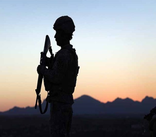 NOGALES, AZ - JUNE 22: U.S. Army National Guardsman Spc. Bernard Mendoza, 24, watches for illegal immigrants and drug smugglers crossing the U.S.-Mexico border on June 22, 2011 in Nogales, Arizona. The Pentagon recently extended the deployment of some 1,200 guardsmen who were deployed last year to assist with border security on the U.S.-Mexico border until September 30. Soldiers at Early Identification Team (EIT) observation posts in Nogales work 24 hour shifts, each taking turns resting for 4 hours during the night. The National Guard troops are strictly on surveillance duty, although they are armed and have been credited with helping U.S. Border Patrol agents arrest up to 17,000 illegal immigrants crossing into the United States. (Photo by John Moore/Getty Images)