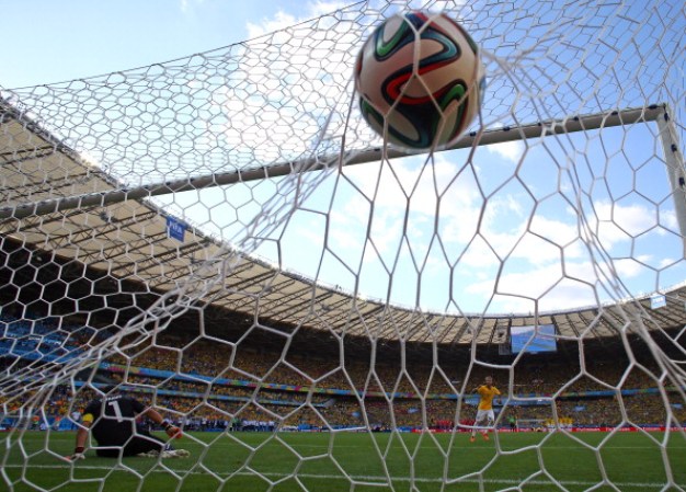 BELO HORIZONTE, BRAZIL - JUNE 28: Neymar of Brazil scores during a penalty shootout past Claudio Bravo of Chile during the 2014 FIFA World Cup Brazil round of 16 match between Brazil and Chile at Estadio Mineirao on June 28, 2014 in Belo Horizonte, Brazil. (Photo by Paul Gilham/Getty Images)
