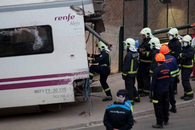 SANTIAGO DE COMPOSTELA, SPAIN - JULY 25: Emergency personnel work at the scene of a train crash on July 25, 2013 at Angrois near Santiago de Compostela, Spain. The crash occurred on Wednesday at 8.40pm as the train approached the north-western Spanish city of Santiago de Compostela, with 247 passengers on board. At least 77 people have died and a further 131 have been reported injured. The crash occurred on the eve of Santiago de Compostela's main religious festival, which has been cancelled by the City's officials. (Photo by Pablo Blazquez Dominguez/Getty Images)