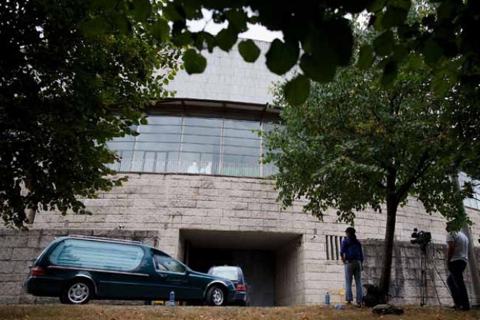 SANTIAGO DE COMPOSTELA, SPAIN - JULY 25: A funeral car arrives at the temporary mortge Multiusos Fontes do Sar Sport Center after a train crashed killing at least 77 people on July 25, 2013 in Santiago de Compostela, Spain. The crash occurred on Wednesday at 8.40pm as the train approached the north-western Spanish city of Santiago de Compostela, with 247 passengers on board. At least 77 people have died and a further 131 have been reported injured. The crash occurred on the eve of Santiago de Compostela's main religious festival, which has been cancelled by the City's officials. (Photo by Pablo Blazquez Dominguez/Getty Images)