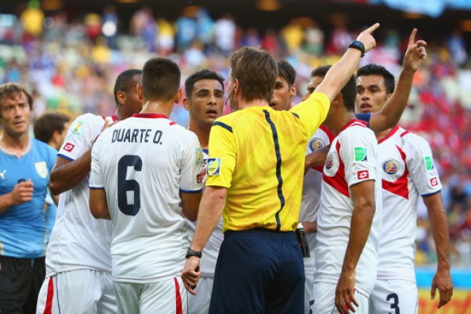 FORTALEZA, BRAZIL - JUNE 14: Costa Rica surround referee Felix Brych after a foul awarding Uruguay a penalty kick during the 2014 FIFA World Cup Brazil Group D match between Uruguay and Costa Rica at Castelao on June 14, 2014 in Fortaleza, Brazil. (Photo by Robert Cianflone/Getty Images)