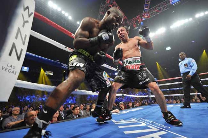 LAS VEGAS, NV - OCTOBER 12: Juan Manuel Marquez (R) looks to strike WBO welterweight champion Timothy Bradley Jr. during their bout at the Thomas & Mack Center on October 12, 2013 in Las Vegas, Nevada. Timothy Bradley Jr. wins in a split-decision victory over Juan Manuel Marquez. (Photo by Jeff Bottari/Getty Images)