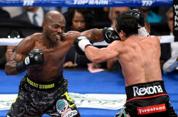 LAS VEGAS, NV - OCTOBER 12: WBO welterweight champion Timothy Bradley Jr. (L) hits Juan Manuel Marquez in the seventh round of their bout at the Thomas & Mack Center on October 12, 2013 in Las Vegas, Nevada. Bradley won in a split decision. (Photo by Ethan Miller/Getty Images)