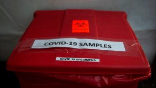 A bucket used to collect samples after people have been tested for coronavirus, COVID-19, is seen at a drive through testing site in Arlington, Virginia on March 20, 2020