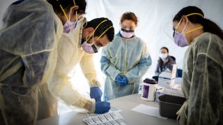 Medical professionals in protective masks and gowns