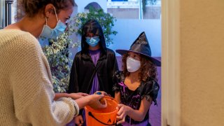 Children dressed in halloween costumes Trick-Or-Treating