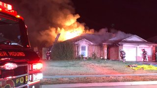 Firefighters in Flower Mound rescued a person trapped inside a bedroom of a burning home early Thursday morning.