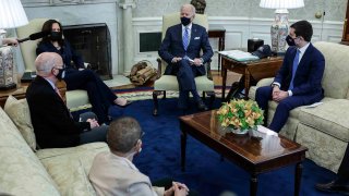 In this March 4, 2021, file photo, President Joe Biden, Vice President Kamala Harris, and Transportation Secretary Pete Buttigieg meet with a bipartisan group of House members on infrastructure in the Oval Office of the White House in Washington, D.C. Participants include Rep. Peter DeFazio (D-OR) (left) and Rep. Eleanor Holmes Norton (D-DC) (center).