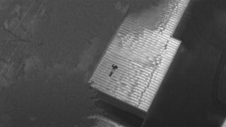 thermal picture of a man on a storage shed