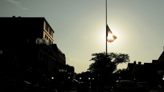 A half-mast flag flies in Highland Park on July 5, 2022.