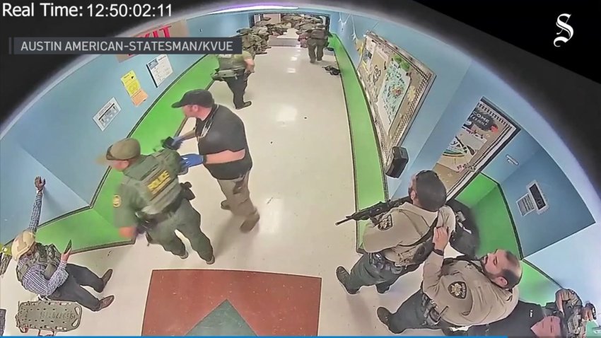 Video obtained by the Austin American-Statesman and KVUE-TV show officers massing in the hallway at Robb Elementary on May 24, moments before breaching a classroom and killing a gunman who fatally shot 19 children and two teachers.