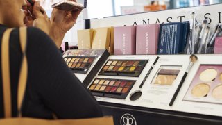 A customer applies Anastasia Beverly Hills eye shadow on display for sale at an Ulta Beauty Inc. store