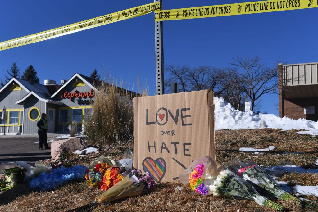 Bouquets of flowers and a sign reading &#8220;Love Over Hate&#8221; are left near Club Q, an LGBTQ nightclub in Colorado Springs, Colorado, on November 20, 2022. &#8211; At least five people were killed and 18 wounded in a mass shooting at an LGBTQ nightclub in the US city of Colorado Springs, police said on November 20, 2022. (Photo by Jason Connolly / AFP) (Photo by JASON CONNOLLY/AFP via Getty Images)