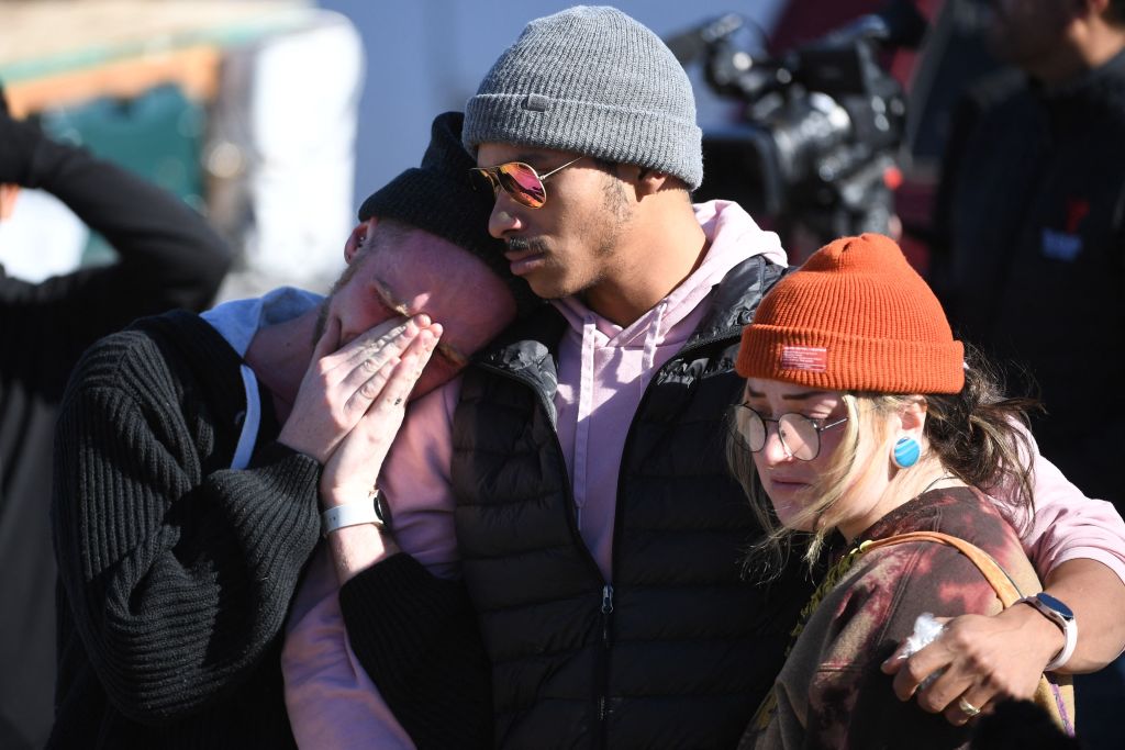 (L-R) Tyler Johnston, his fiance, Keenan Mastes-Holmes, and Altas Pretzeus embrace while paying their repsects at a memorial for the vicitms of the mass shooting at Club Q, an LGBTQ nightclub, in Colorado Springs, Colorado, on November 20, 2022. &#8211; At least five people were killed and 18 wounded in a mass shooting at an LGBTQ nightclub in the US city of Colorado Springs, police said on November 20, 2022. (Photo by Jason Connolly / AFP) (Photo by JASON CONNOLLY/AFP via Getty Images)