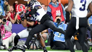 Georgia Bulldogs wide receiver Adonai Mitchell (5) catches a touchdown pass while TCU Horned Frogs cornerback Josh Newton (24) defends during the first half the CFP National Championship game at SoFi Stadium on Monday, Jan. 9, 2023 in Los Angeles, CA.