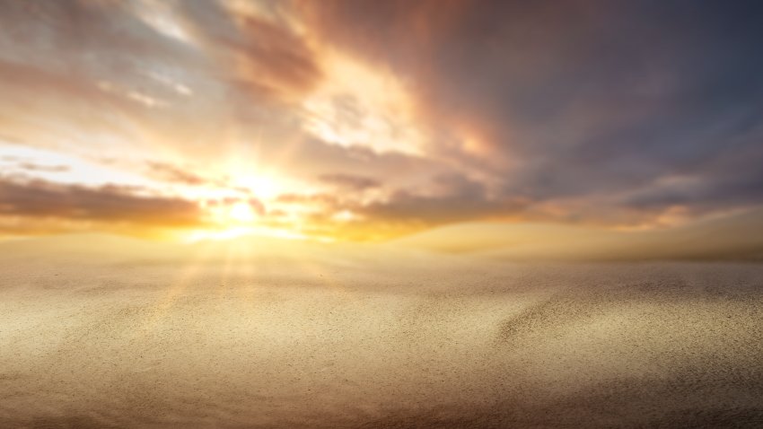 Views of sand dunes with a sunset sky background