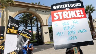 Strike signage is seen on the picket line outside Paramount Studios