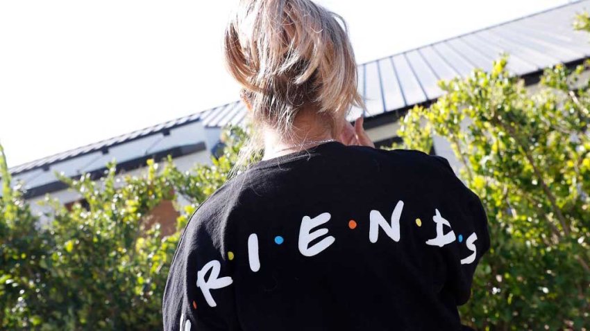 A fan pays her respects outside the house of actor Matthew Perry on October 29, 2023 in Los Angeles, California. Perry, 54, was known globally for his portrayal of wise-cracking character Chandler Bing on the wildly popular “Friends,” which ran for 10 seasons from 1994 to 2004. First responders found Perry unconscious in a hot tub at his house on October 28 and were unable to revive him, law enforcement sources told the Los Angeles Times. Police confirmed they’d mounted a “death investigation for a male in his 50s.” (Photo by Michael Tran / AFP) (Photo by MICHAEL TRAN/AFP via Getty Images)