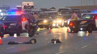 Police respond to the scene of a shooting on the 105 Freeway near Willowbrook on Sunday, Nov. 19, 2023.