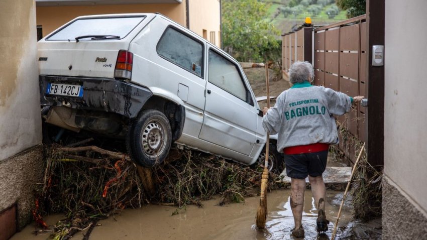 TOPSHOT – A woman tries to clean the mud in Montemurlo near Prato after heavy rain last night, on November 3, 2023. Storm Ciaran hit Tuscany late on November 2, 2023 causing the death of five people according to authorities. (Photo by Federico SCOPPA / AFP) (Photo by FEDERICO SCOPPA/AFP via Getty Images)