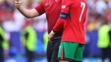 DORTMUND, GERMANY - JUNE 22: A fan runs on the pitch for a photo with Cristiano Ronaldo of Portugal during the UEFA EURO 2024 group stage match between Turkiye and Portugal at Football Stadium Dortmund on June 22, 2024 in Dortmund, Germany.(Photo by Robbie Jay Barratt - AMA/Getty Images)