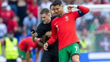 A pitch invader takes a selfie photograph with Portugal forward Cristiano Ronaldo during the UEFA Euro 2024 Group F match between Turkiye v Portugal, at the BVB Stadion Dortmund in Dortmund, Germany, on June 22, 2024. (Photo by Andrzej Iwanczuk/NurPhoto via Getty Images)