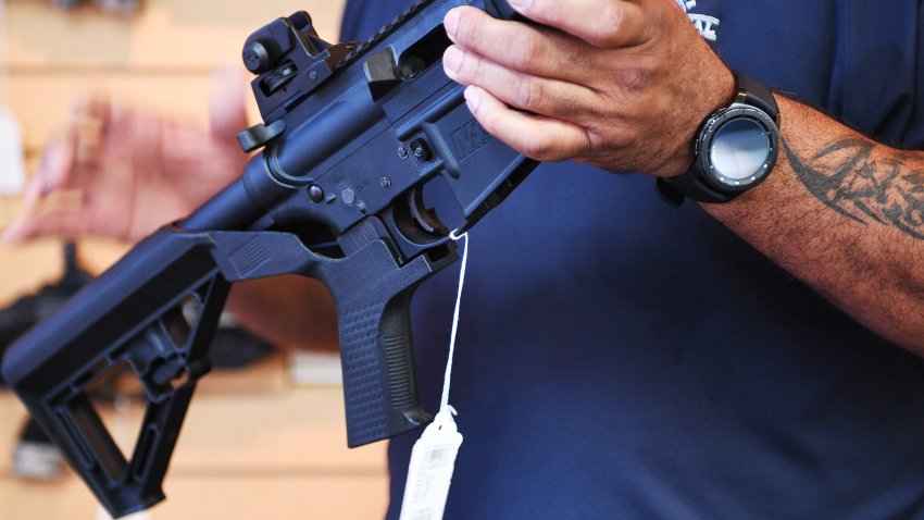 Senior Sales Staff Mark Warner shows a bump stock installed on an AR-15 rifle at Blue Ridge Arsenal in Chantilly, Virgina, on October 6, 2017. (Photo by JIM WATSON / AFP) (Photo by JIM WATSON/AFP via Getty Images)