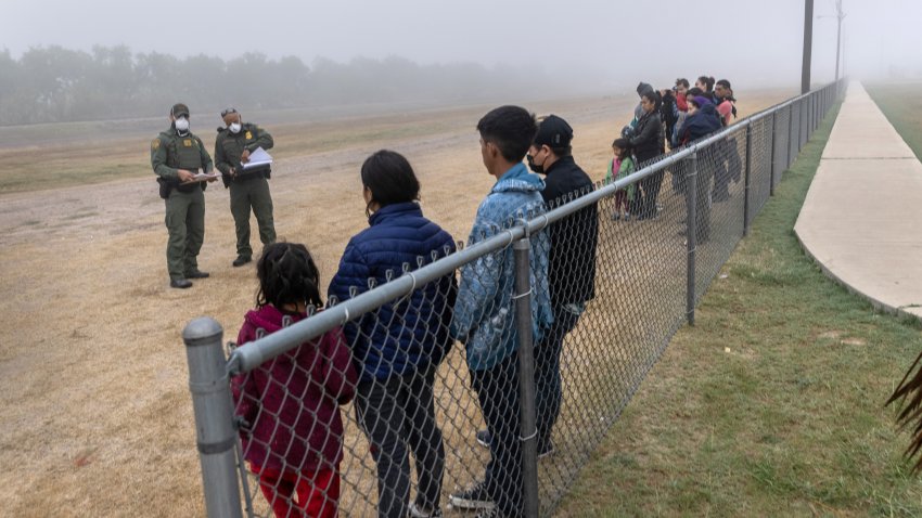 LA JOYA, TEXAS – APRIL 10: Unaccompanied minors (L), are grouped apart from families waiting to be processed by U.S. Border Patrol agents near the U.S.-Mexico border on April 10, 2021 in La Joya, Texas. A surge of immigrants crossing into the United States, including record numbers of children, continues along the southern border. (Photo by John Moore/Getty Images)