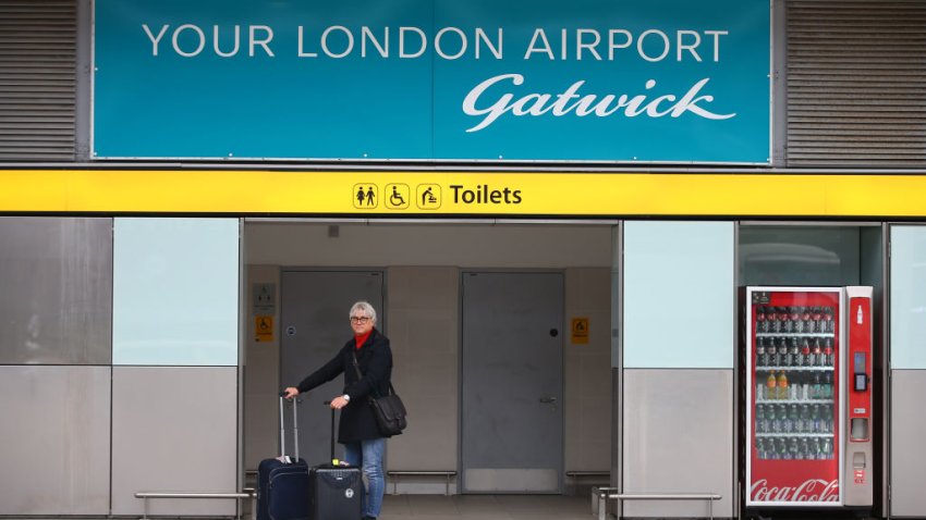 LONDON, ENGLAND – MARCH 27: A traveller stands with her luggage at Gatwick Airport on March 27, 2022 in London, England. Gatwick’s South terminal closed in June 2020 to reduce costs during the Coronvirus pandemic when traveller numbers reduced significantly. It has undergone months of refurbishment and re-opens today to meet the expected increased demand for air travel over Easter and the coming summer now that restrictions have been lifted. (Photo by Hollie Adams/Getty Images)