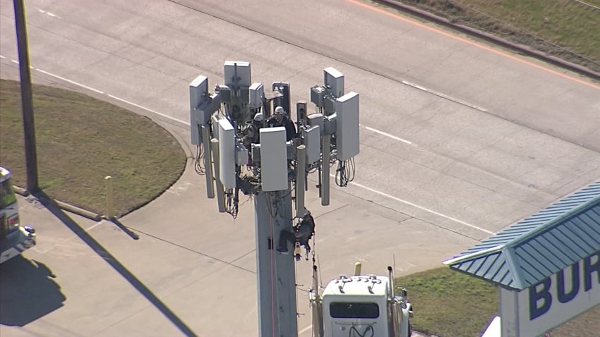 Workers on a cell phone tower in Burleson, Texas, Jan. 24, 2025.