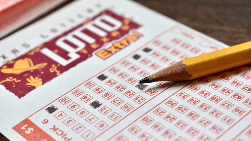 Lotto ticket with pencil on wooden table