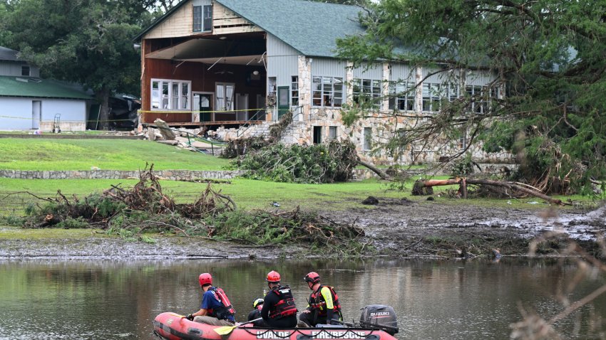 TOPSHOT – A search and rescue team looks for people along the Guadalupe River near a damaged building at Camp Mystic in Hunt, Texas, on July 7, 2025, following severe flash flooding that occurred during the July 4 holiday weekend. Rescuers in Texas continue to race against time to find dozens of missing people, including children, swept away by flash floods that killed more than 80 people, with forecasters warning of new deluges. In a terrifying display of nature’s power, the rain-swollen waters of the Guadalupe River reached treetops and the roofs of cabins in Camp Mystic as girls slept overnight on Friday, July 4, washing away some of them and leaving a scene of devastation. (Photo by RONALDO SCHEMIDT / AFP) (Photo by RONALDO SCHEMIDT/AFP via Getty Images)